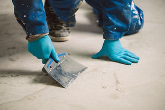 worker removing irregularities on floor
