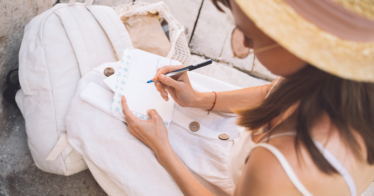 A person writing goals in a journal while reflecting on practical steps to improve sleep and wellbeing