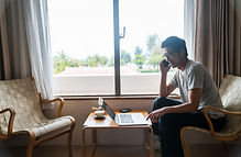 窓のそばで仕事する男性