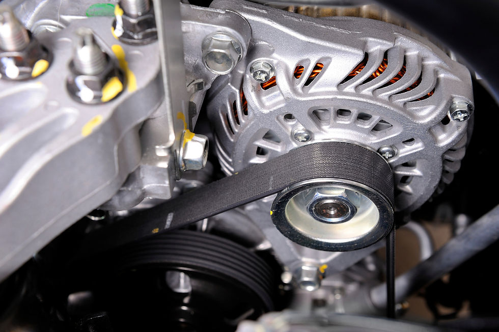 Close up of a black textured wet belt fitted tightly over a metal engine pulley
