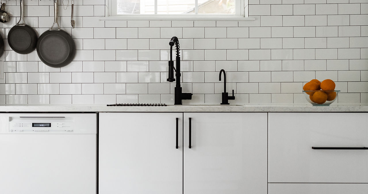 Kitchen sink and white subway tile backsplash