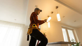 Electrician securing electrical systems, insured by Gaylord Insurance.