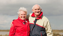 Old senior couple by lake, family picture