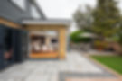 A general interior view of a Home extension with open patio doors