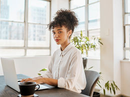 woman sitting at a desk working on a computer