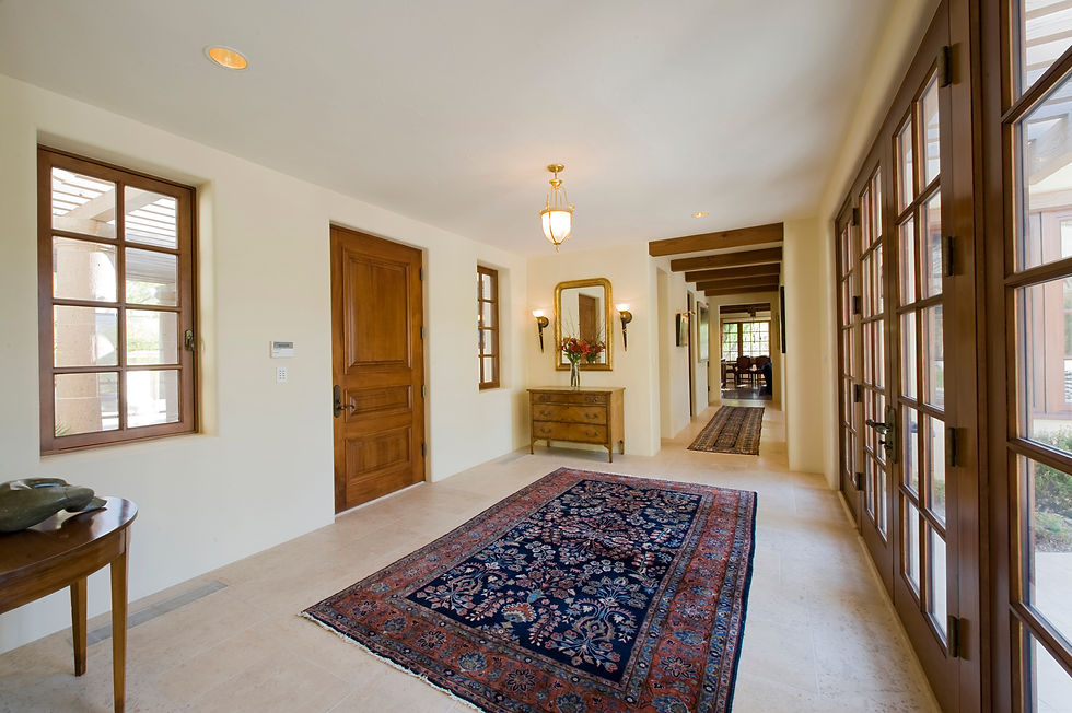 A modern hallway with large ornate rug.