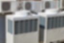 large air conditioners outside next to an office building