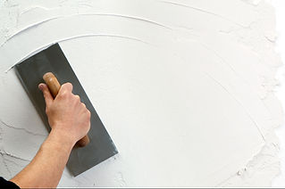Worker plastering a wall