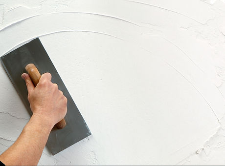 hand holding plastering tool