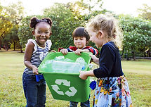 Girls Carrying a Recycling Bin