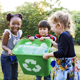 Girls Carrying a Recycling Bin