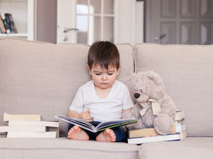 Child reading independently by a sunlit window building focus attention span and lifelong reading habits