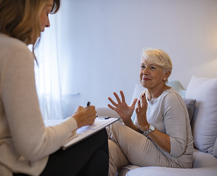 Psychotherapy session in Bradford Ontario, woman smiling during somatic therapy for anxiety with a female therapist