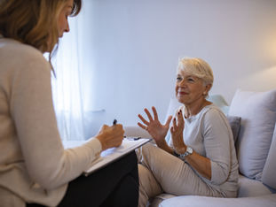 An older woman speaking with a therapist.