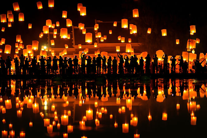 People launching floating lanterns