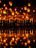 People launching floating lanterns