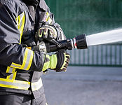 Firefighter Spraying Hose