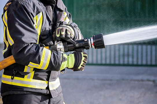 Firefighter Spraying Hose