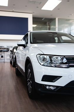 A vibrant red SUV with a modern design and roof rails.