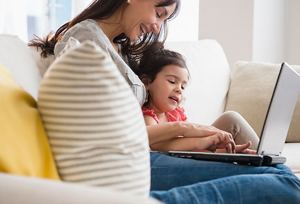 A mother and daughter use a laptop together