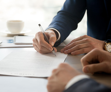 Man in Suit Signing
