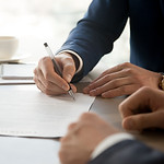 Man in Suit Signing