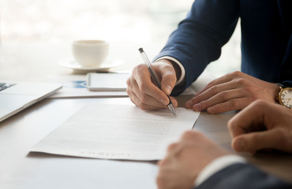 Man in Suit Signing