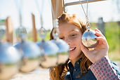 A Girl Looking at a Pendulum Model