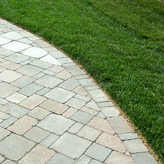 Curved landscaping of random stones and grass