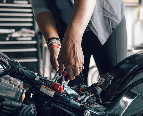 Mechanic Repairing Motorcycle 