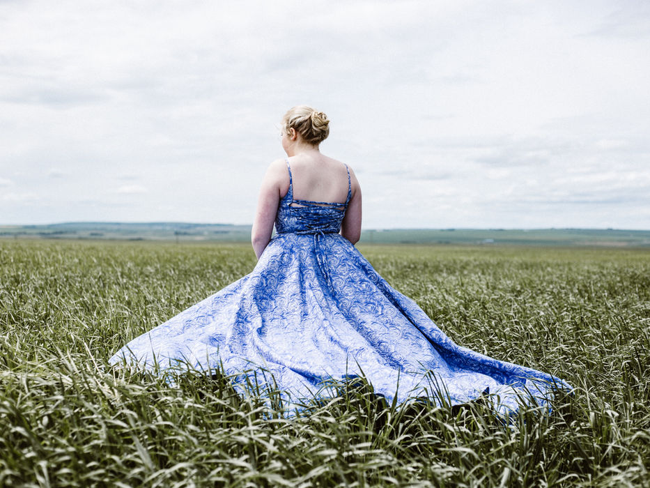 Woman in blue dress in a field