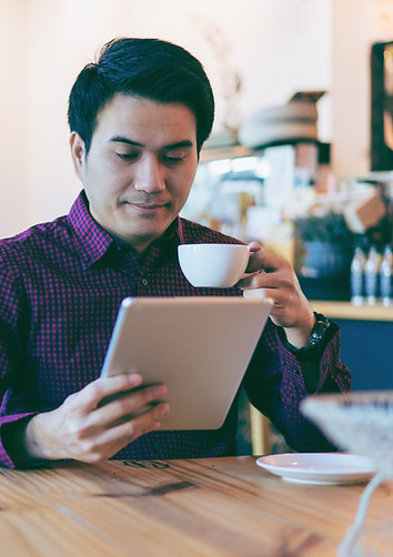 Office Worker reading a paper with Coffee