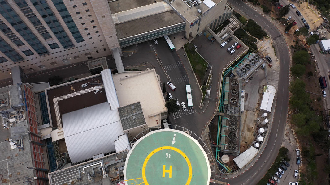An aerial photo of the urban area with a helicopter pad. 