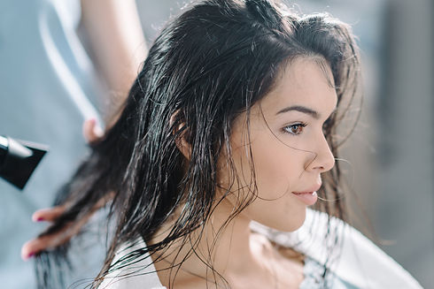 A woman receiving a hair treatment at a salon