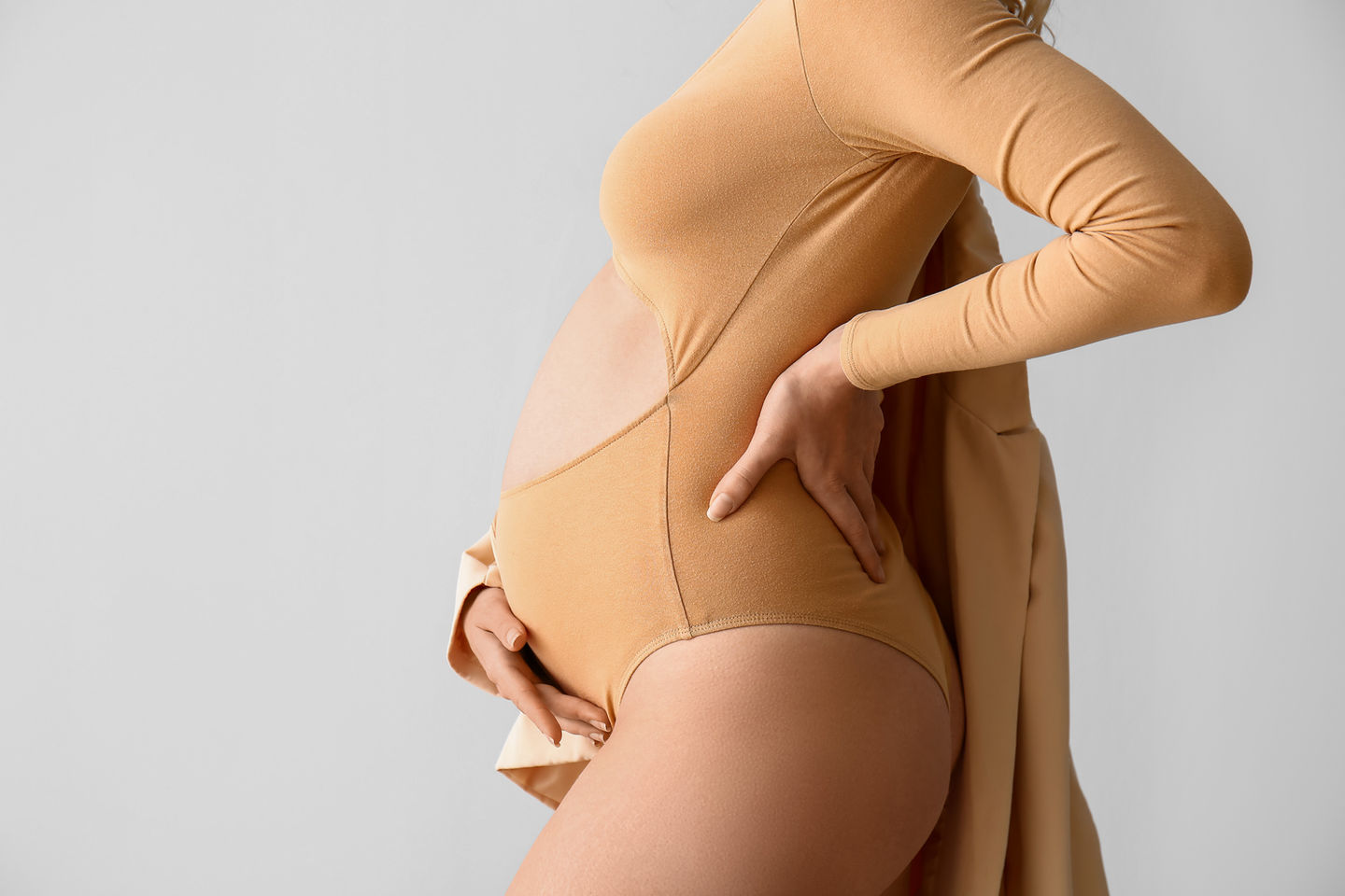 Maternity Photography by Blake Ferguson showcases a woman presenting her Baby Bump in revealing clothing, captured in the Studio of Ontario, Canada. (2)