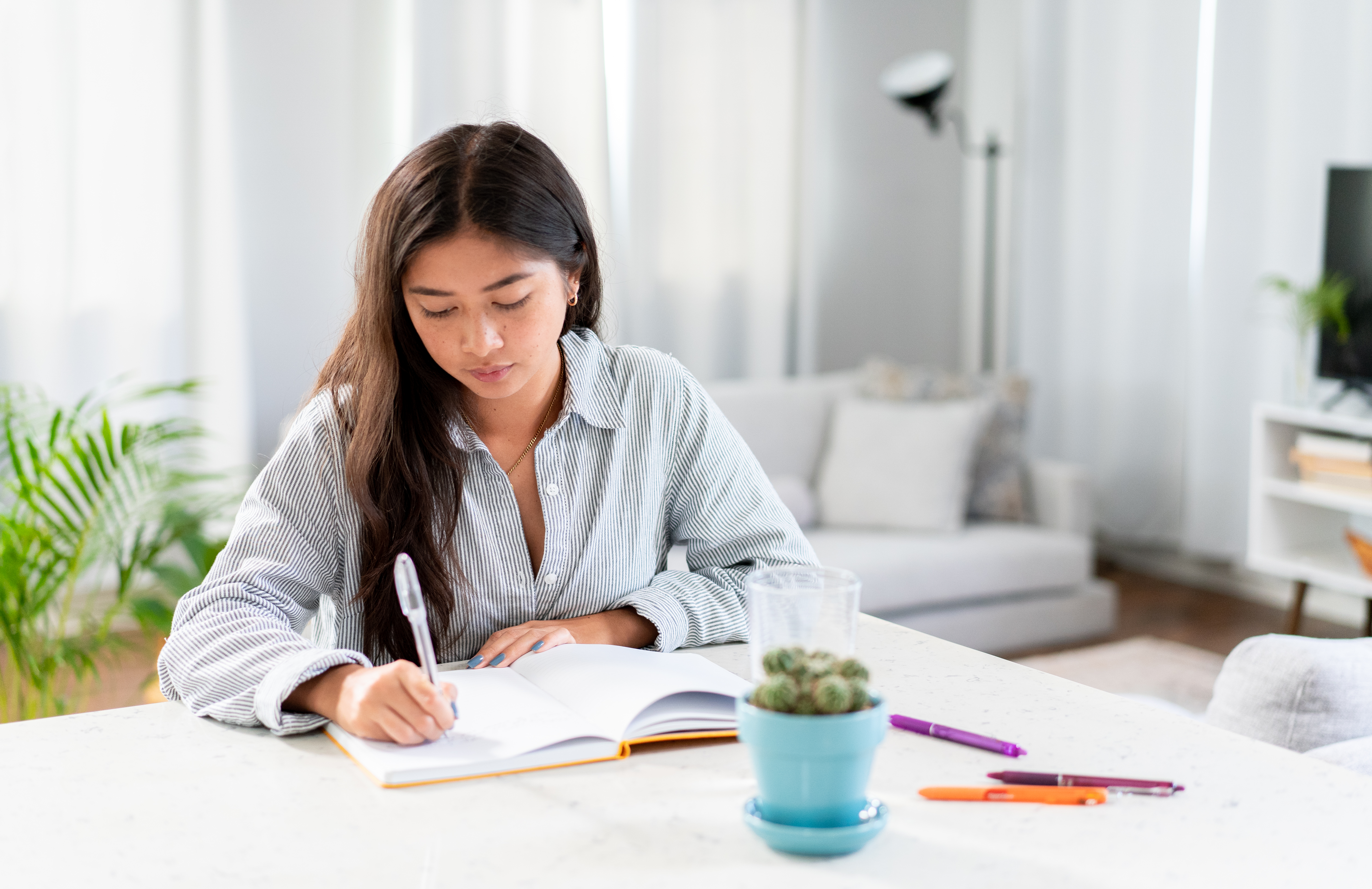 A woman writing on a book