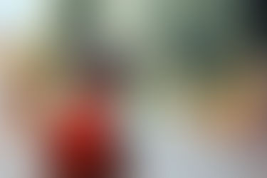 Little girl wearing a red back pack, ready for school