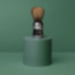 Shaving brush display inside barbershop.