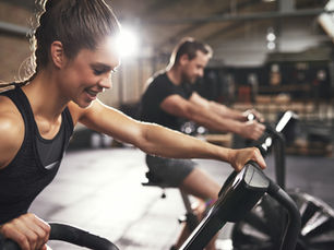 Girl exercising on an assault bike.