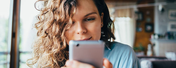 Person smiling at phone