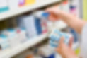 Pharmacy worker sorting medication on the shelf