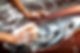 Detail of hands using a sponge to wash a car headlight with thick soap suds