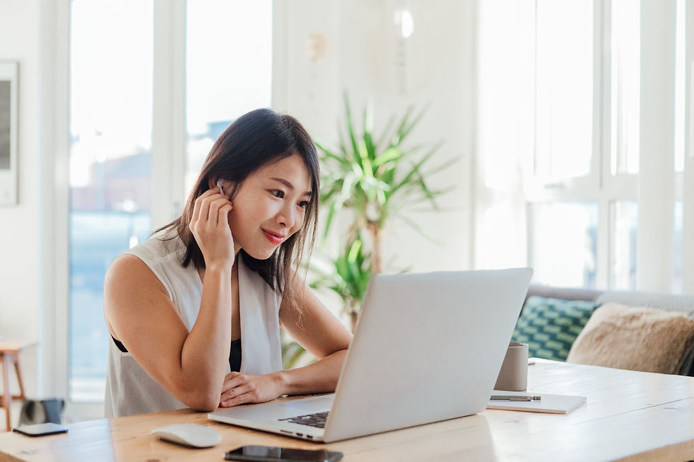 Young woman on a video conference using laptop at home