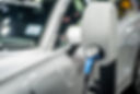 EV Car or Electric vehicle at charging station with the power cable supply plugged in on b