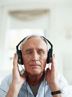 Elderly man listening with headphones