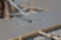 Freshly poured concrete is floated on a sidewalk construction project