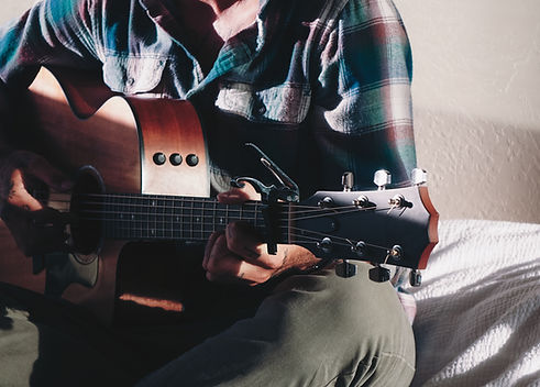 Professional musician practicing guitar