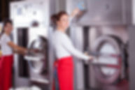 Two women providing laundry services, working together efficiently