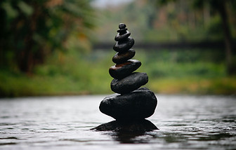 A photograph of a tower of stones balancing