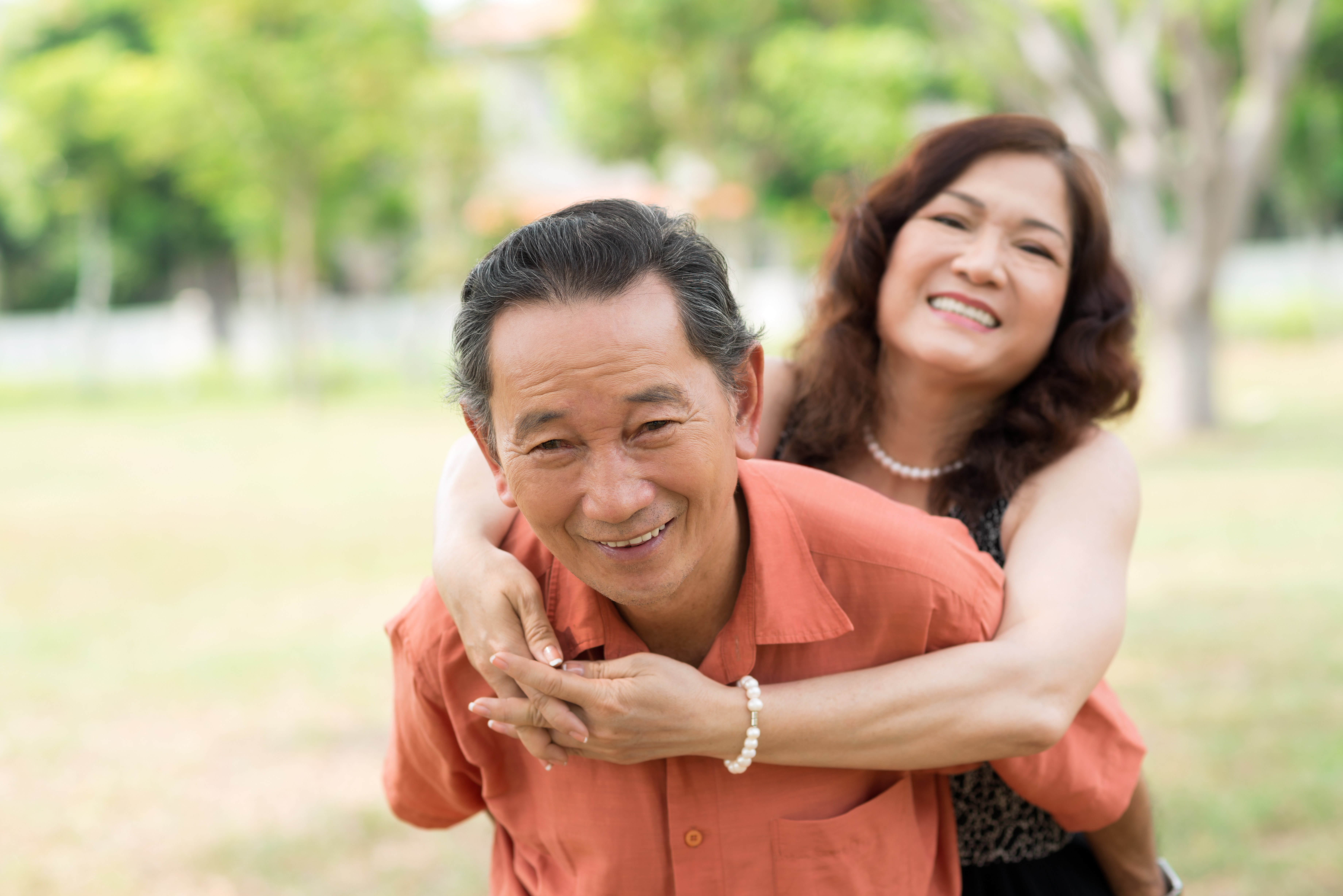 Asian husband piggyback his wife